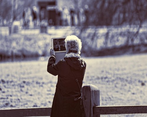 person taking a break from laptop looking out a window