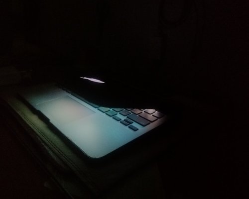 close up of laptop screen with warm light filter on at night